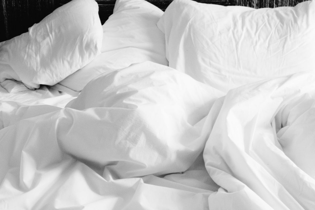 Cozy white bed sheets bedroom lifestyle